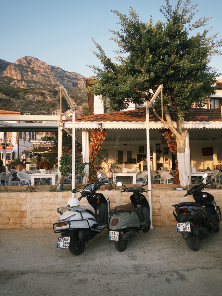 Charming outdoor cafe in Kalkan with a mountain backdrop