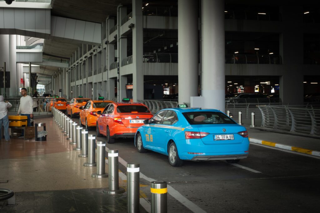 Taxis lined up at an airport arrival terminal