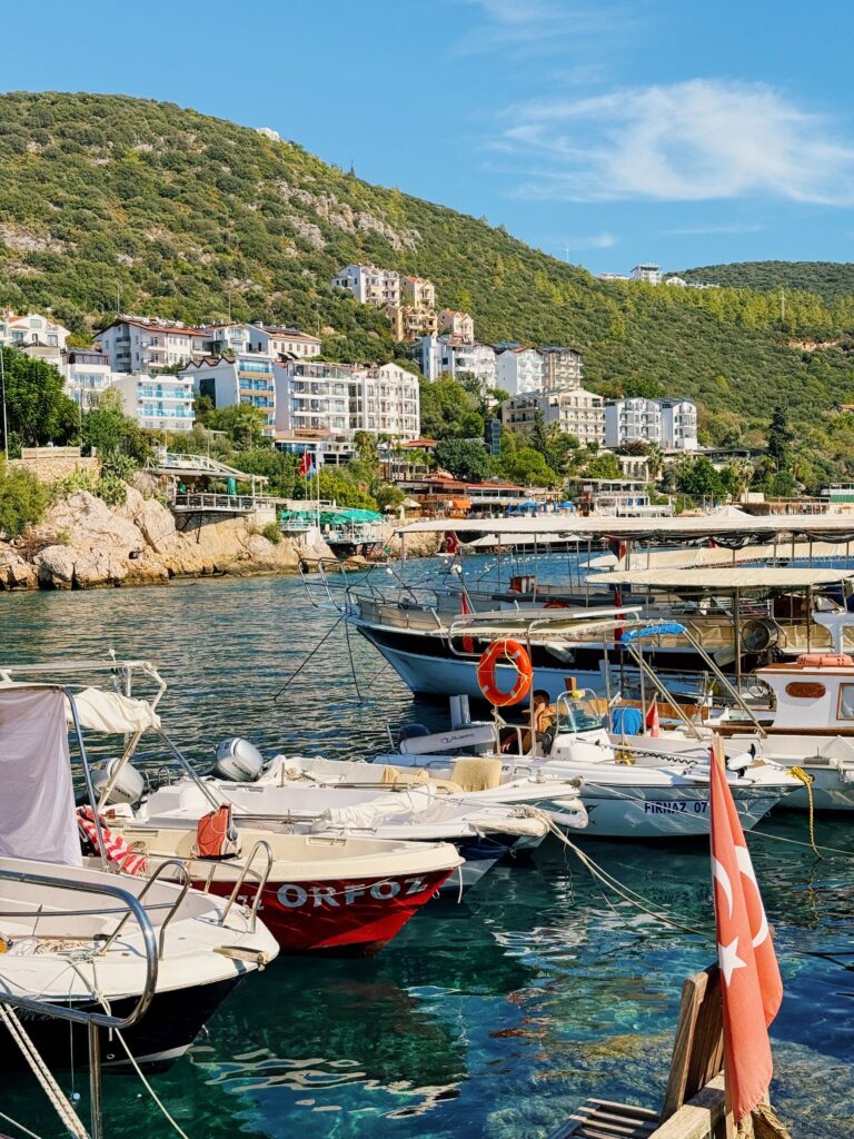 Picturesque harbor in Kas, Turkey with boats and hillside houses