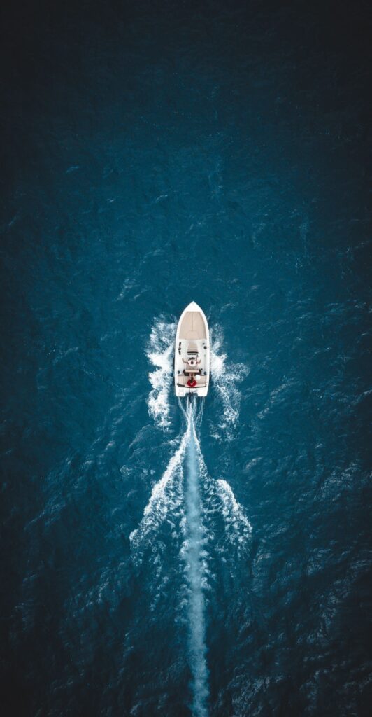 Ship sailing in turquoise sea water