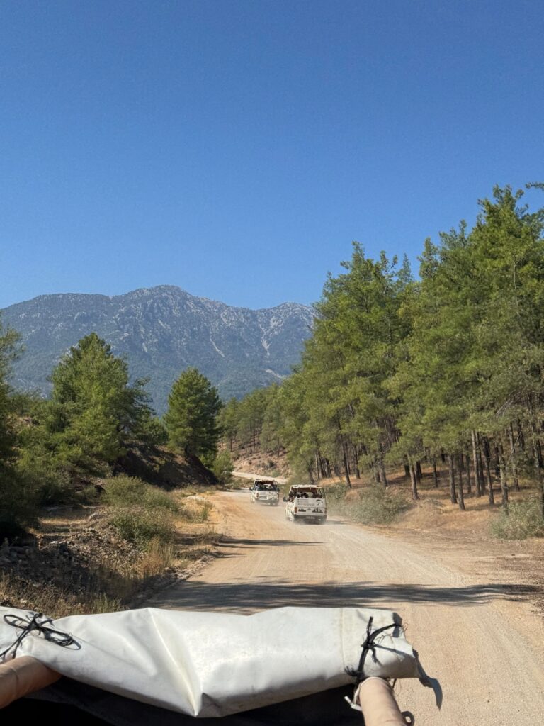 Jeeps driving on a dirt road through mountainous forest landscape near Antalya