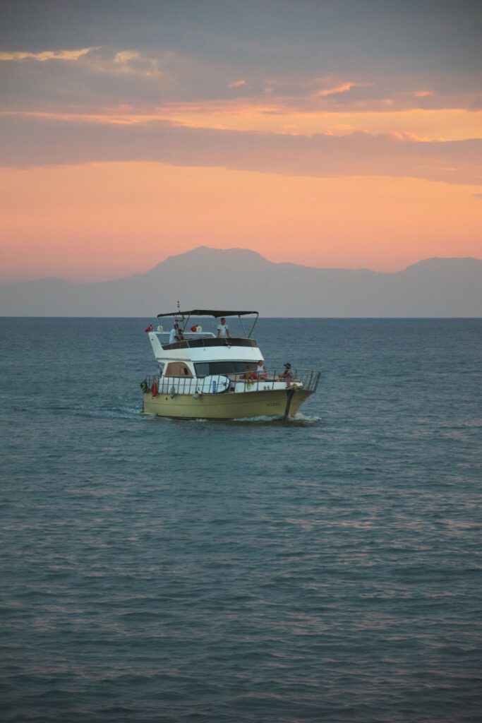Boat sailing along the Antalya coast during a beautiful sunset