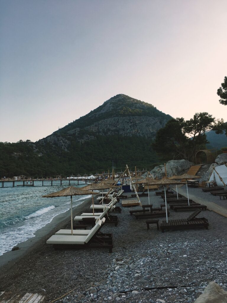 Serene Antalya beach with loungers and mountain views