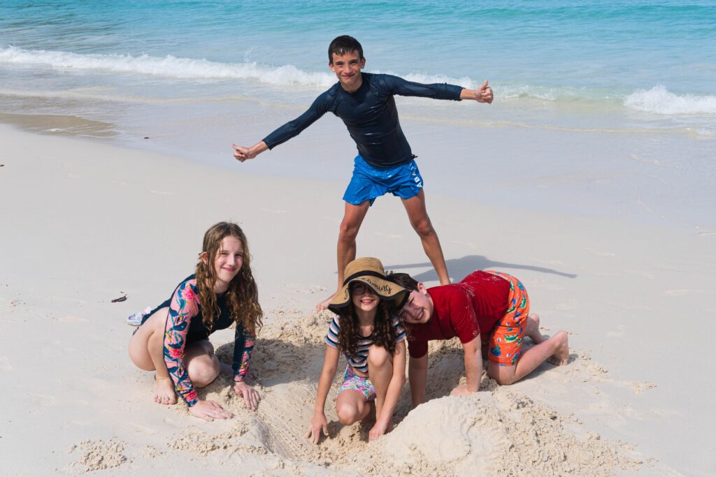Group of children building a sandcastle at the beach