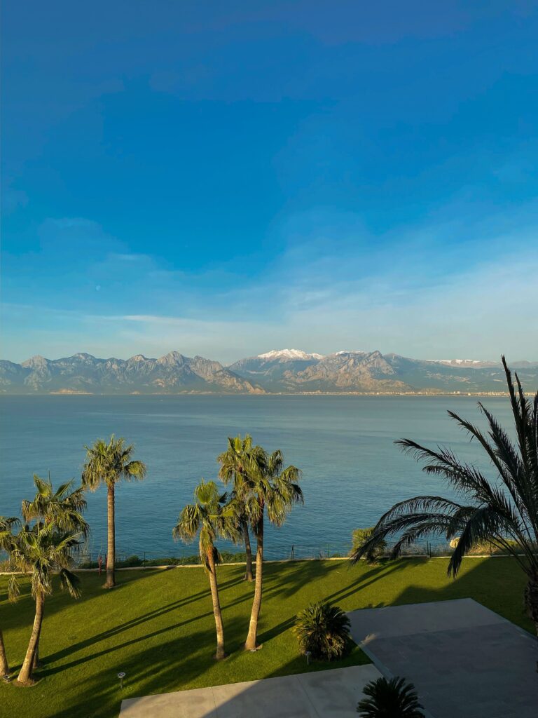 Scenic Antalya coastline with mountains and palm trees