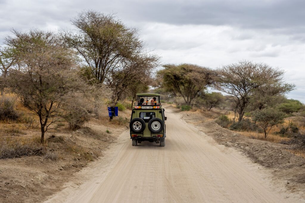 A safari jeep on a dirt road