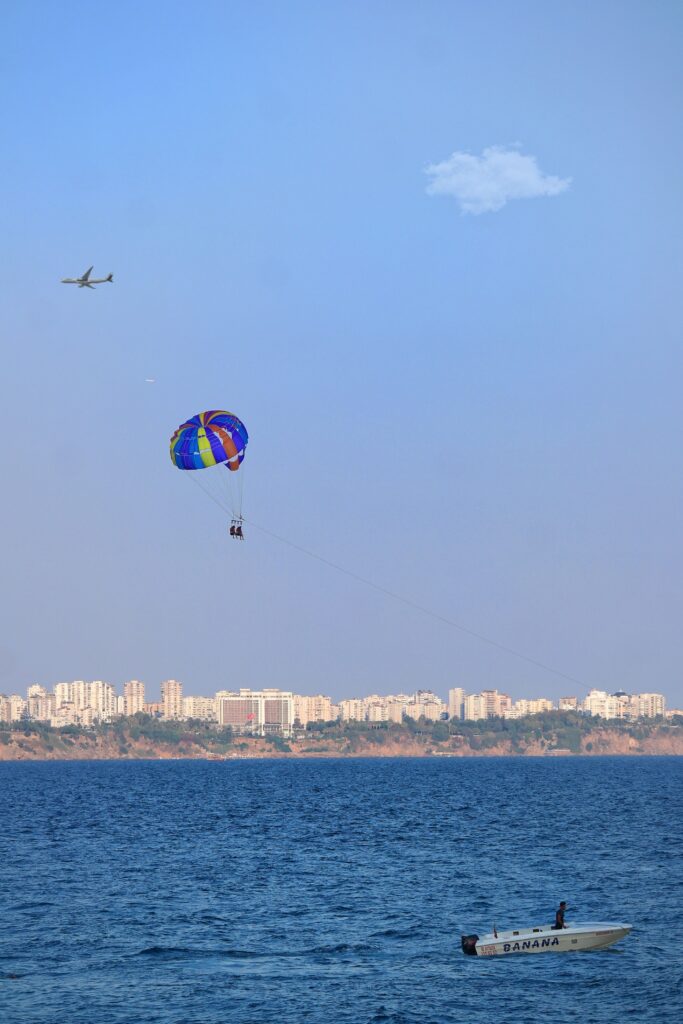 Parasailing over the Mediterranean Sea with Antalya skyline in the background