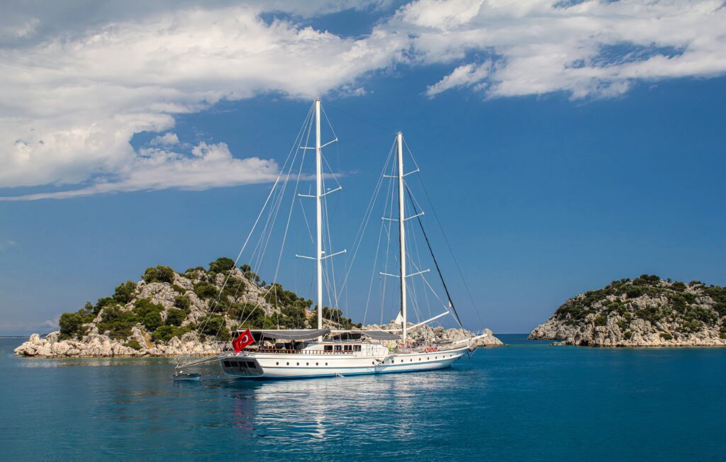 Sailing yacht anchored near rocky islands off the coast of Antalya