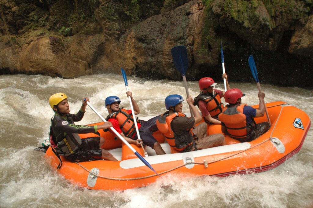 Group of people whitewater rafting in a canyon