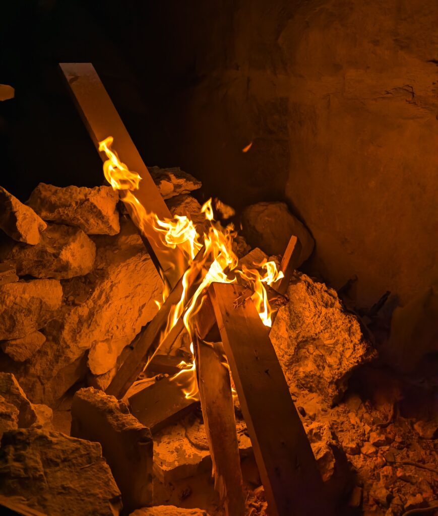 Flames burning among rocks in a natural rocky setting at night
