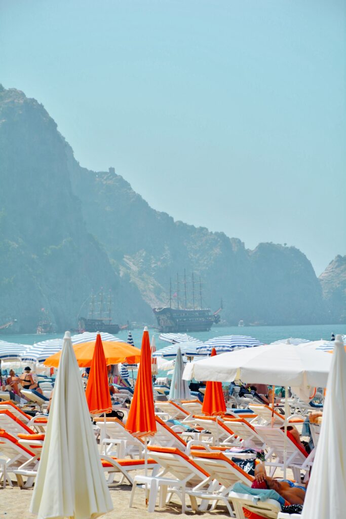 Sun loungers and umbrellas on a Turkish Riviera public beach near Kemer, Antalya