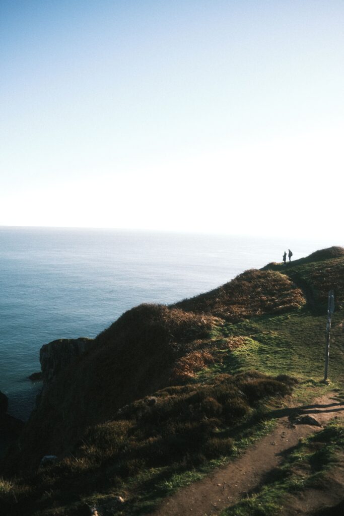 A coastal hiking path along cliffs above turquoise sea, similar to the Lycian Way trail in Turkey