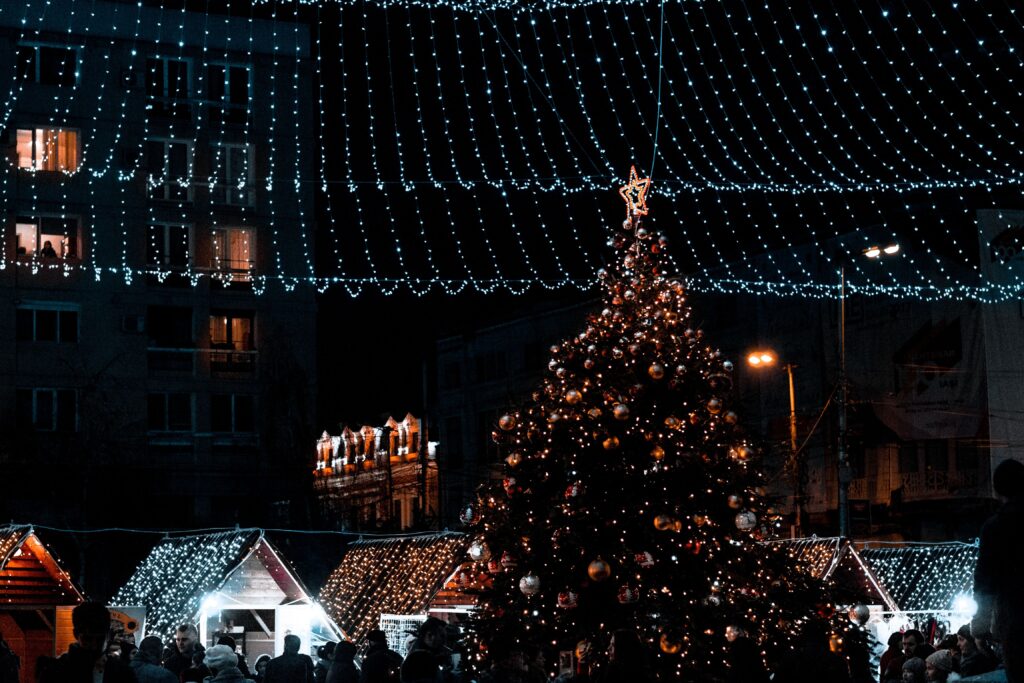 A festively lit Christmas tree and lights at night, representing the holiday season atmosphere in Antalya