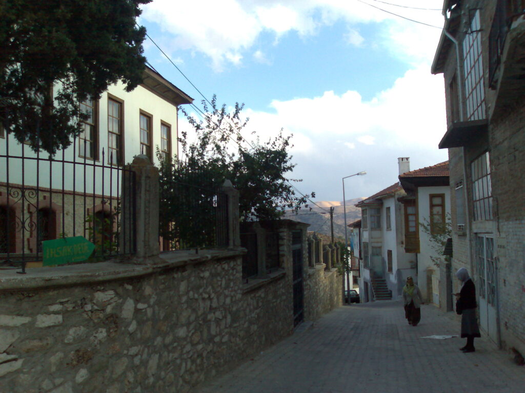 A cobbled street lined with old two-storey houses in Elmalı
