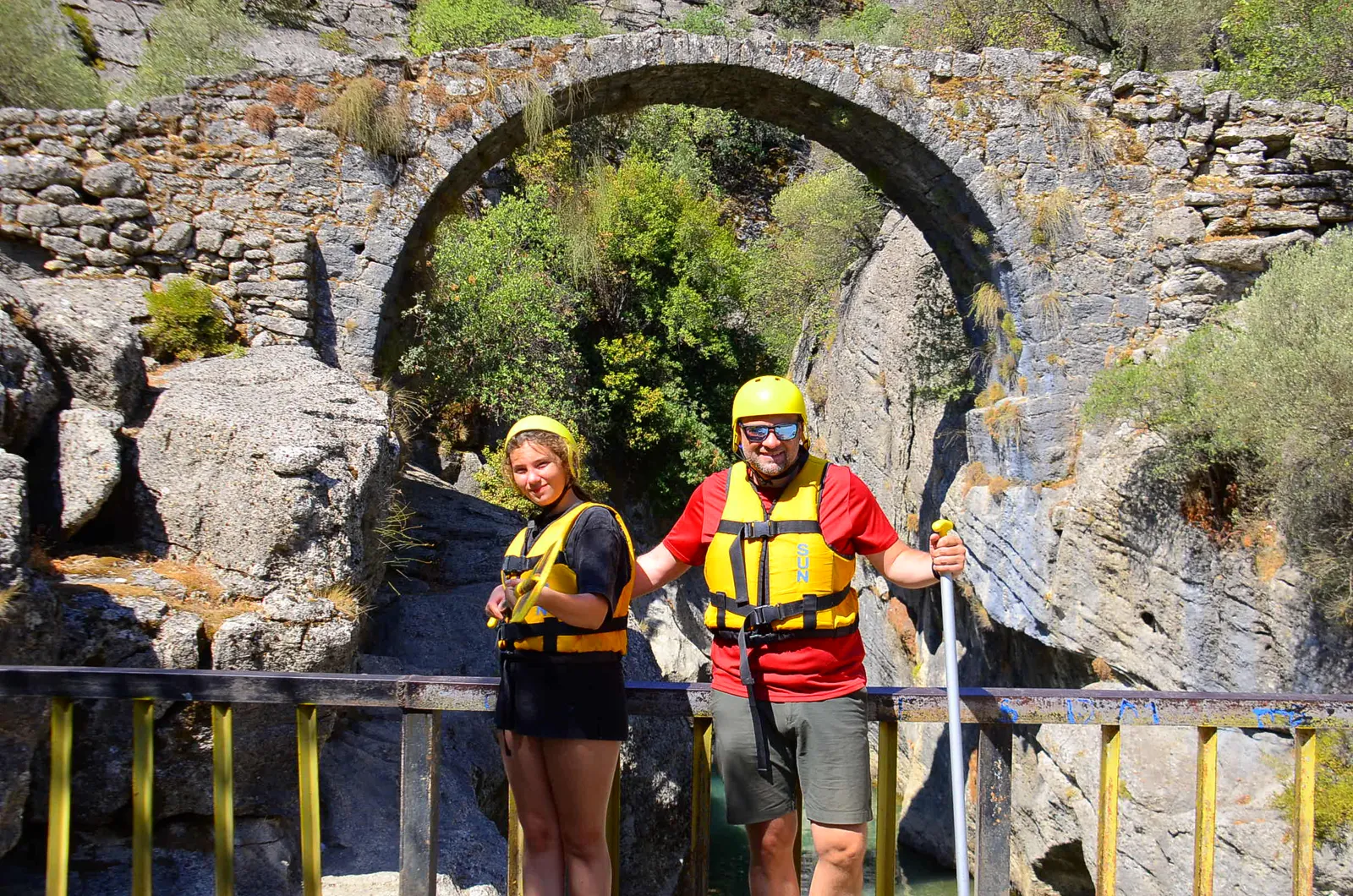 Rafting guests standing in front of the Roman-era Oluk Bridge in Köprülü Canyon