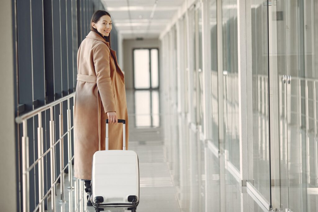 Traveller walking with a suitcase through an airport hallway after landing in Antalya