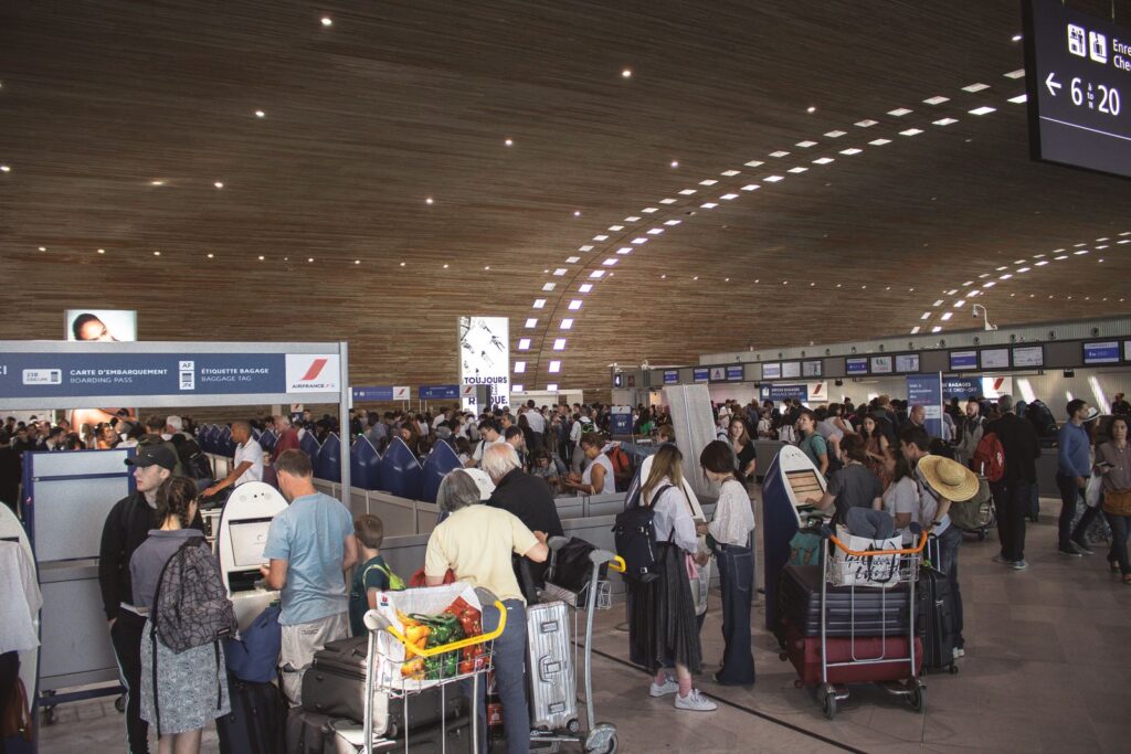 Travellers in an airport departures area before their flight