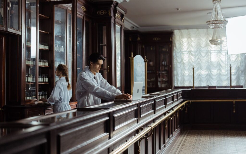 Pharmacists working behind the counter of a traditional pharmacy